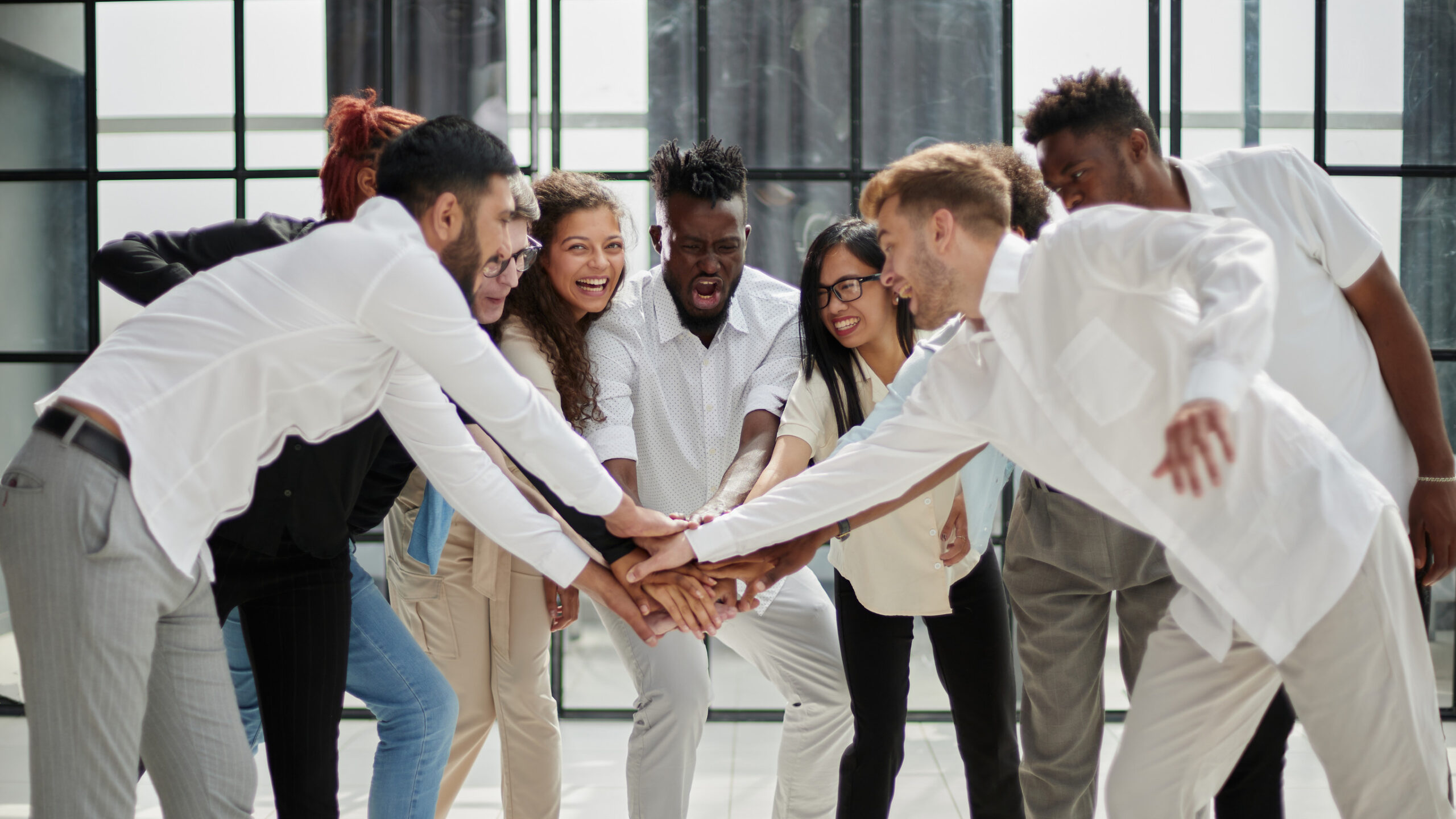 high angle view of multiracial friend stacking hand together