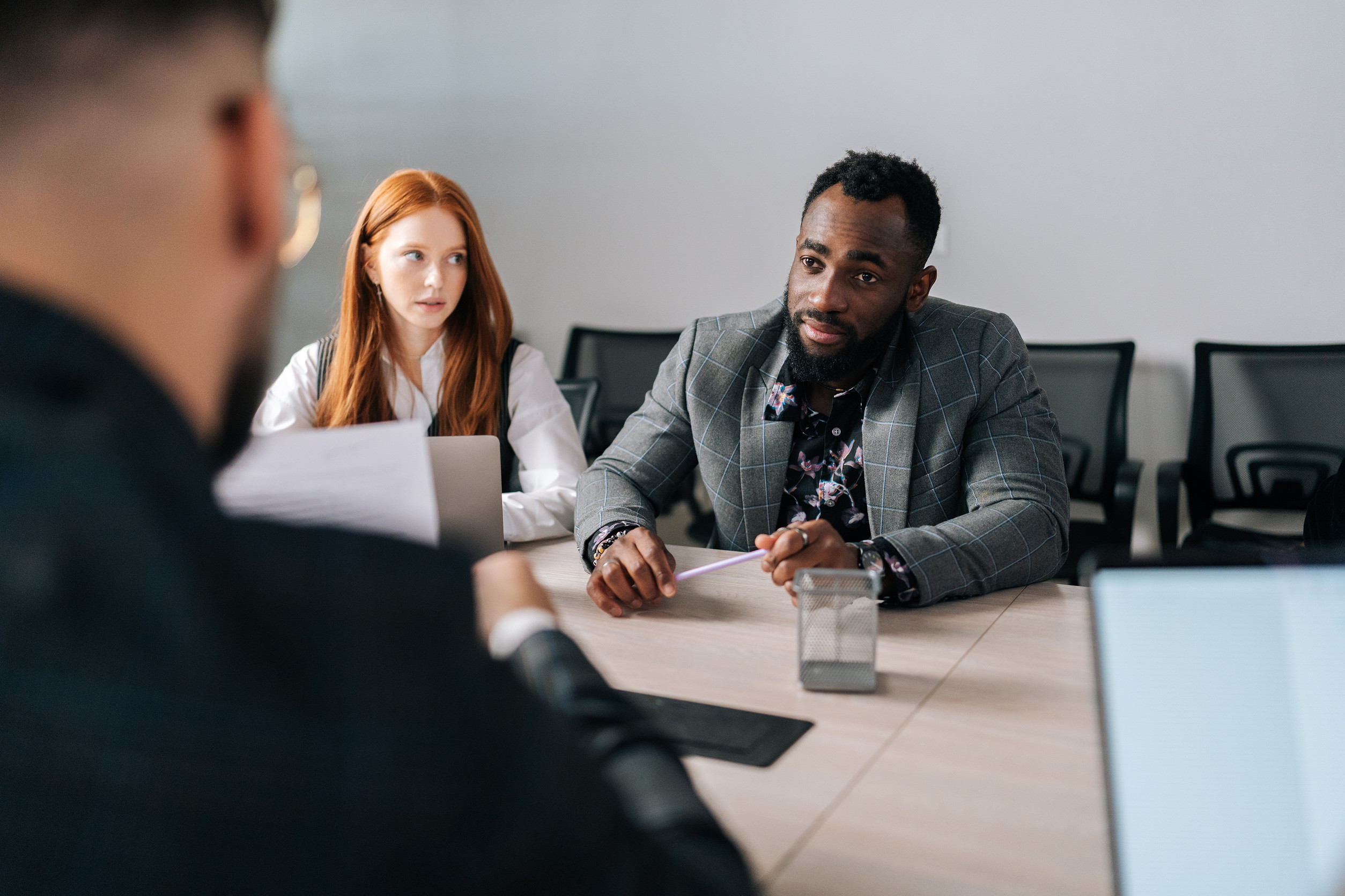 closeup back view of unrecognizable male job candidate apply have interview with diverse employers at office meeting. man applicant speak on work recruitment